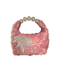 A pink sequined shoulder bag with a pearl-bead handle and a silver sequined palm leaf embellishment on the front, shown against a plain white background.