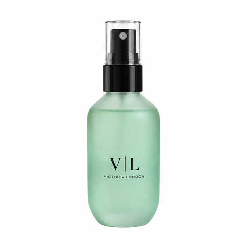 Dewy Setting Spray in a frosted mint green bottle with black spray nozzle – Victoria London