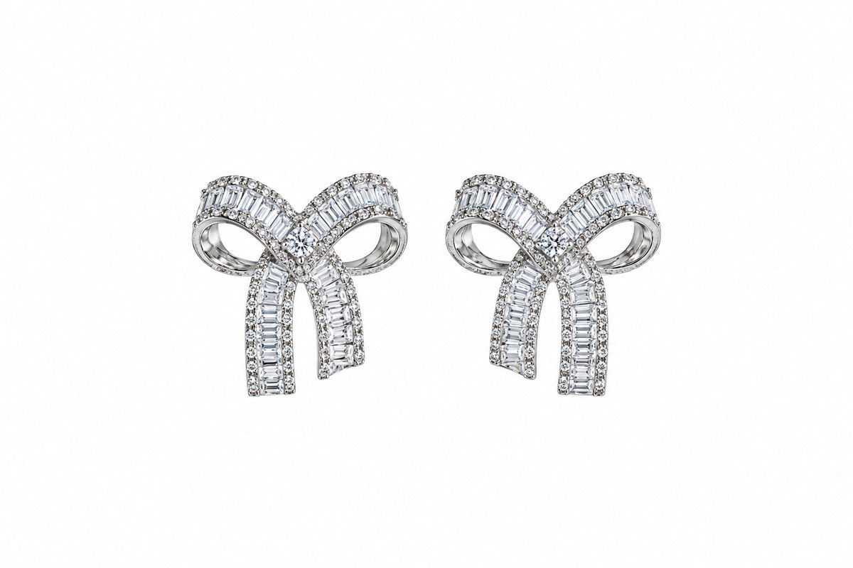 The Crystal Baguette Bow Earrings in silver tone with channel-set baguette crystals and pavé trim – Victoria London